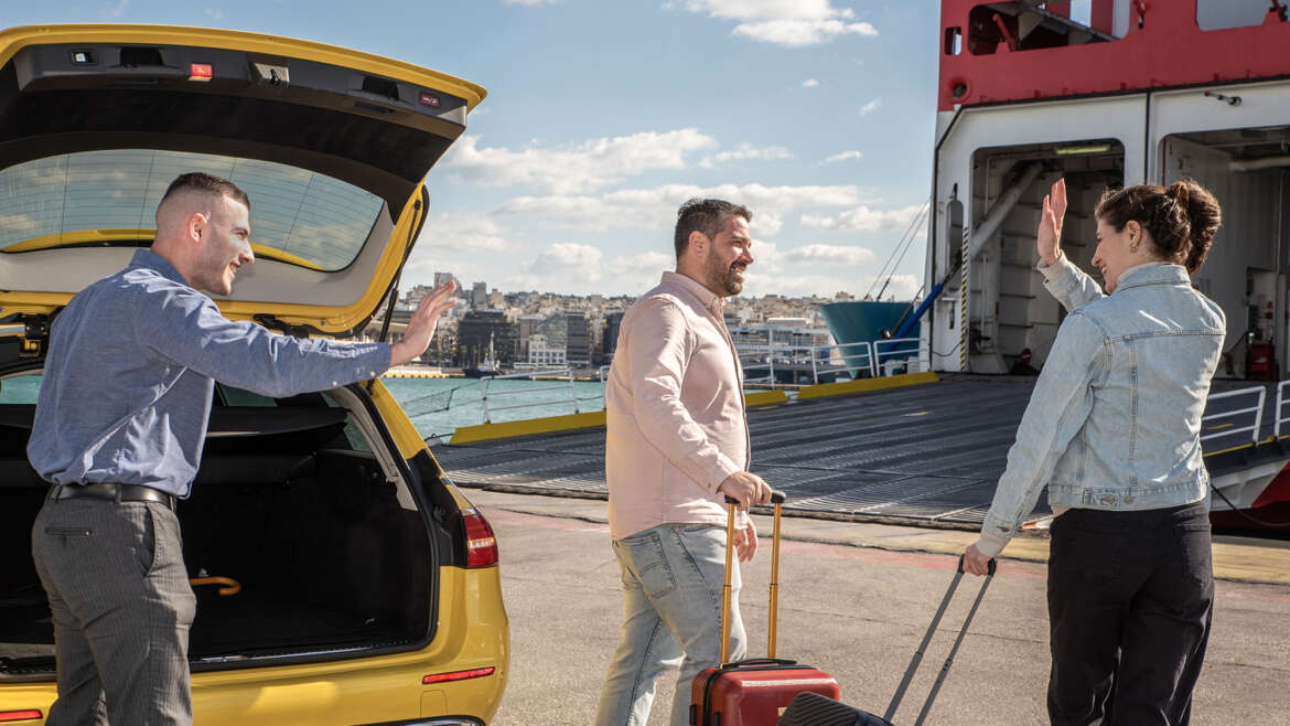 Couple waving goodbye to taxi driver at Piraeus Port