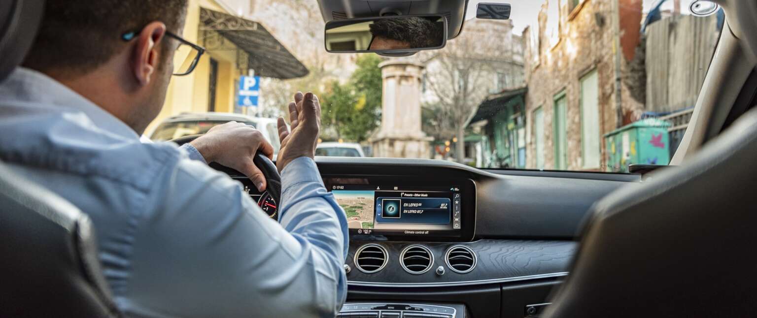 Urban Cabs driver showing Athens to passengers.