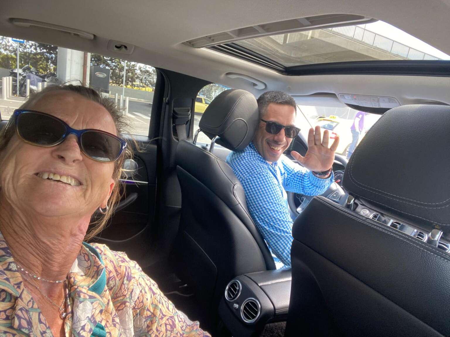 Happy customer selfie with driver during Athens sightseeing ride